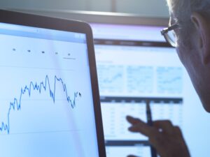 Manager monitoring IoT asset performance data on dashboard screens