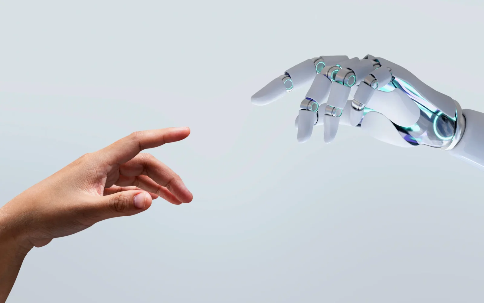 Robotic hand reaching toward a human hand, representing physical AI's dependence on connectivity infrastructure