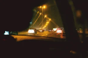 View from inside a car's interior looking out at a freeway with surrounding traffic